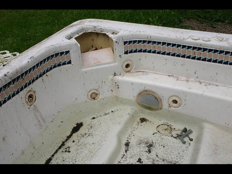 Hot tub removal crew dismantling an old spa in a San Diego backyard